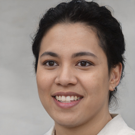 Joyful asian young-adult female with medium  brown hair and brown eyes