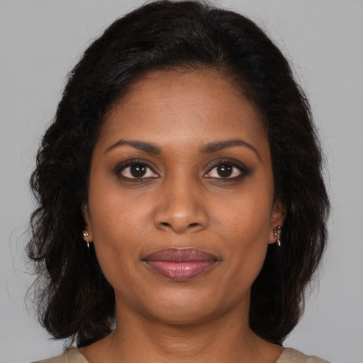 Joyful black young-adult female with medium  brown hair and brown eyes
