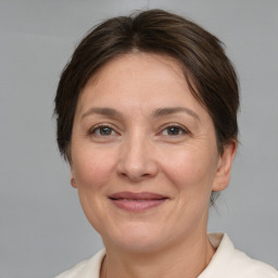 Joyful white adult female with short  brown hair and brown eyes