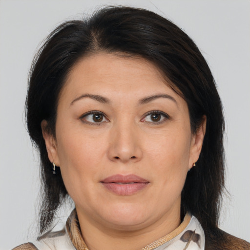 Joyful white adult female with medium  brown hair and brown eyes