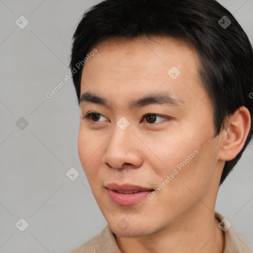 Joyful asian young-adult male with short  black hair and brown eyes