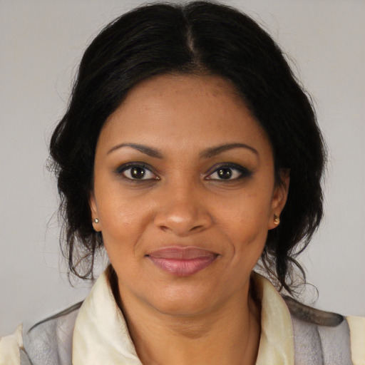 Joyful black adult female with medium  black hair and brown eyes