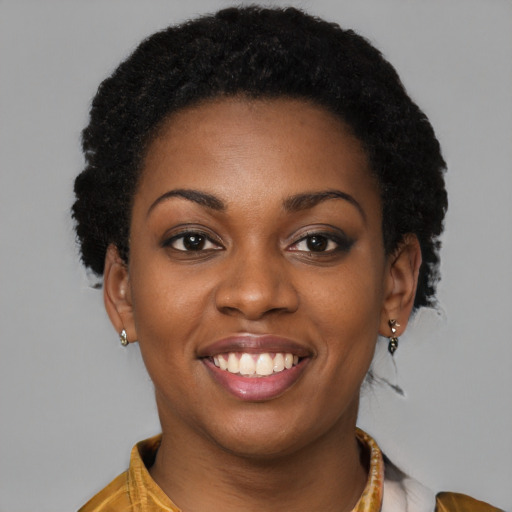 Joyful black young-adult female with long  brown hair and brown eyes