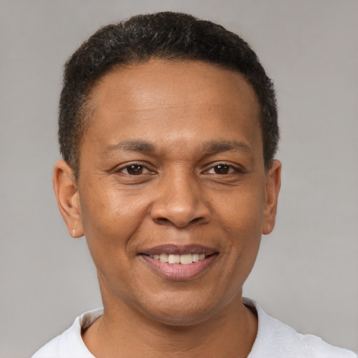 Joyful latino adult male with short  brown hair and brown eyes