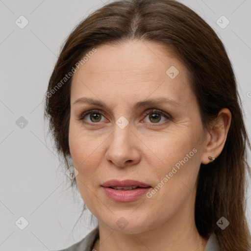 Joyful white adult female with long  brown hair and brown eyes