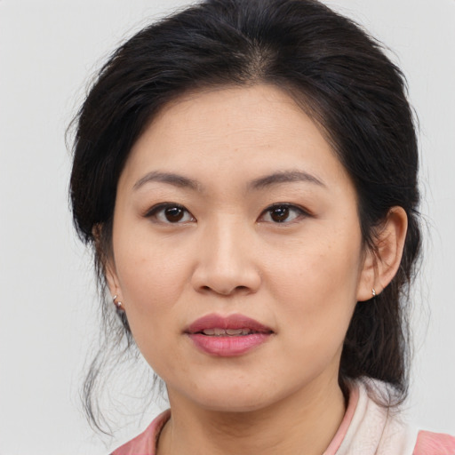 Joyful asian young-adult female with medium  brown hair and brown eyes