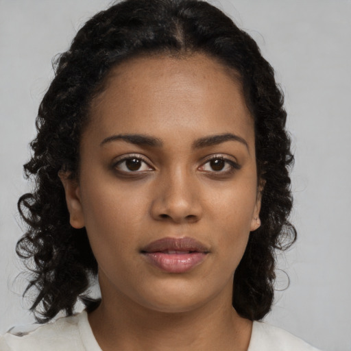 Neutral black young-adult female with medium  brown hair and brown eyes
