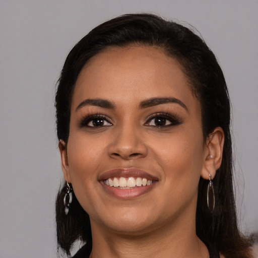 Joyful white young-adult female with long  black hair and brown eyes