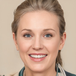 Joyful white adult female with medium  brown hair and blue eyes