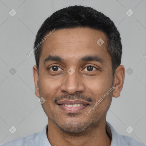 Joyful latino young-adult male with short  black hair and brown eyes