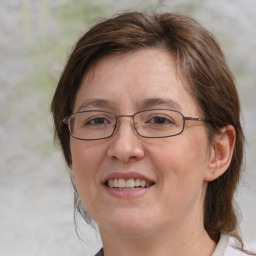 Joyful white adult female with medium  brown hair and brown eyes