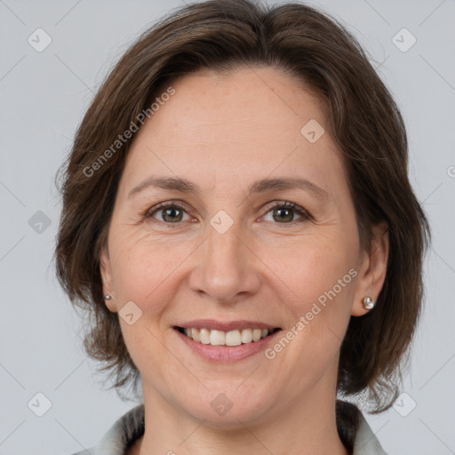 Joyful white adult female with medium  brown hair and brown eyes