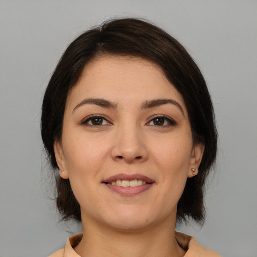 Joyful white young-adult female with medium  brown hair and brown eyes