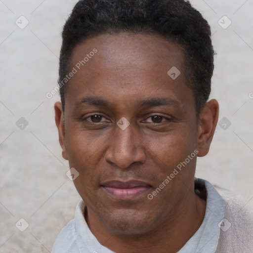 Joyful black adult male with short  black hair and brown eyes