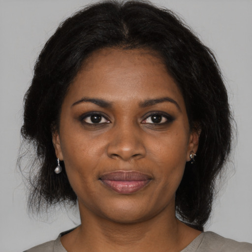 Joyful black young-adult female with medium  brown hair and brown eyes