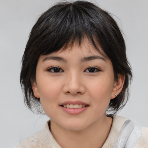 Joyful asian child female with medium  brown hair and brown eyes