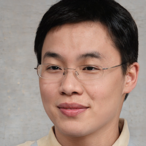 Joyful asian young-adult male with short  brown hair and brown eyes