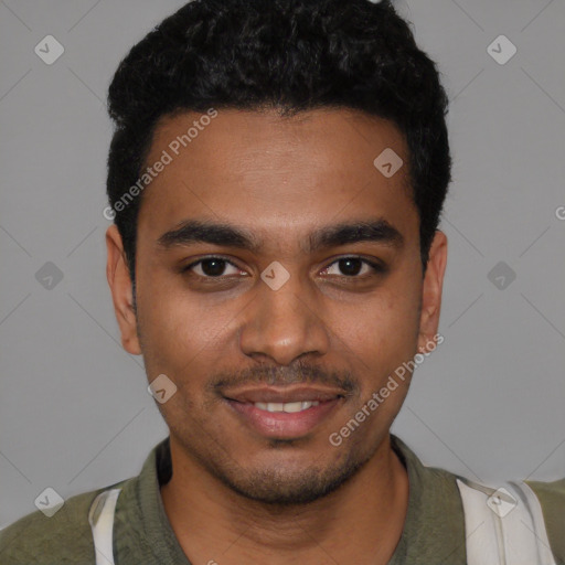 Joyful black young-adult male with short  black hair and brown eyes