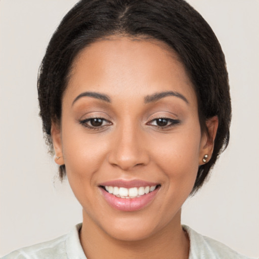 Joyful latino young-adult female with medium  brown hair and brown eyes