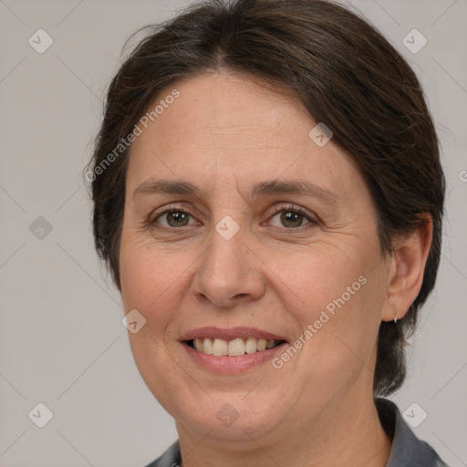 Joyful white adult female with medium  brown hair and brown eyes