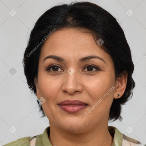 Joyful latino adult female with medium  brown hair and brown eyes