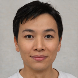 Joyful asian young-adult male with short  black hair and brown eyes