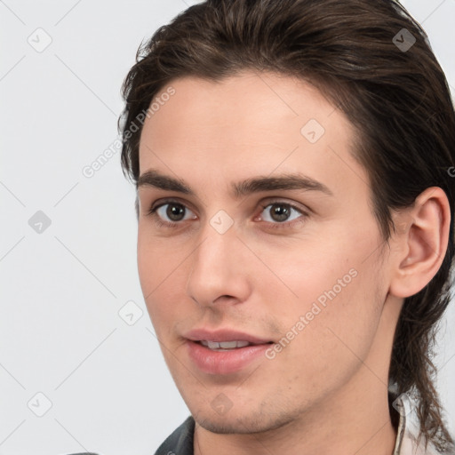 Joyful white young-adult male with medium  brown hair and brown eyes