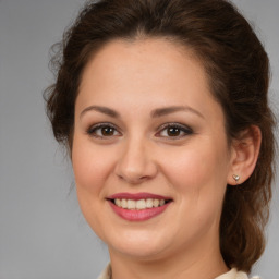 Joyful white young-adult female with medium  brown hair and brown eyes