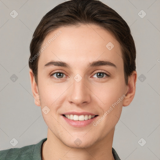 Joyful white young-adult female with short  brown hair and grey eyes