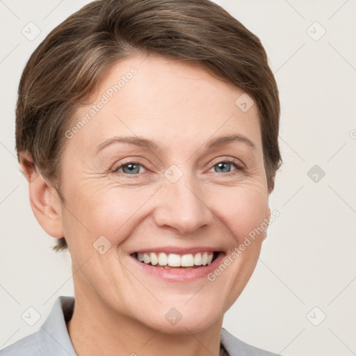 Joyful white adult female with short  brown hair and grey eyes