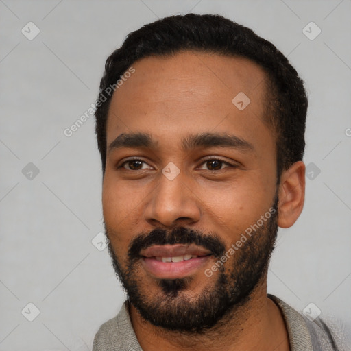 Joyful black young-adult male with short  black hair and brown eyes