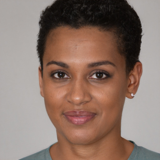Joyful black young-adult female with short  brown hair and brown eyes