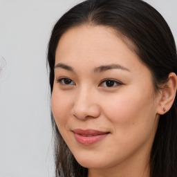 Joyful asian young-adult female with long  brown hair and brown eyes