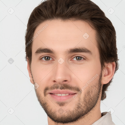 Joyful white young-adult male with short  brown hair and brown eyes