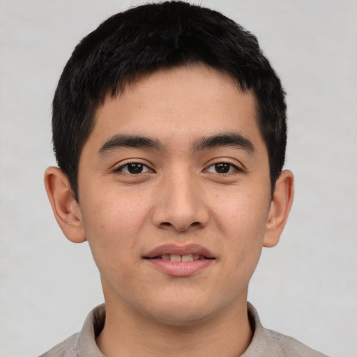 Joyful asian young-adult male with short  black hair and brown eyes