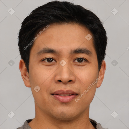 Joyful asian young-adult male with short  brown hair and brown eyes