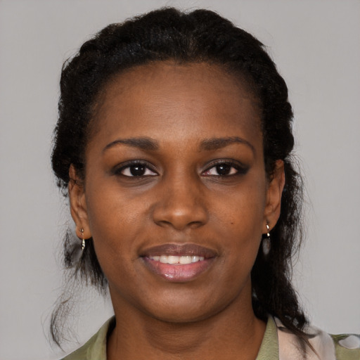 Joyful black young-adult female with medium  black hair and brown eyes