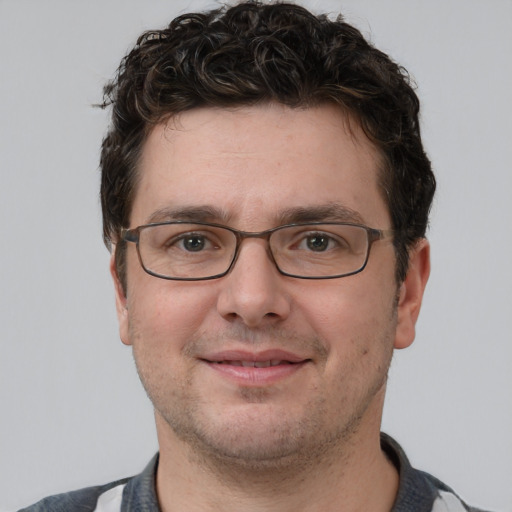 Joyful white adult male with short  brown hair and grey eyes