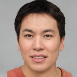 Joyful asian young-adult male with short  brown hair and brown eyes