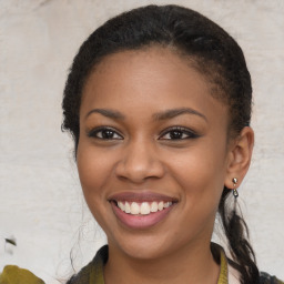 Joyful black young-adult female with medium  brown hair and brown eyes