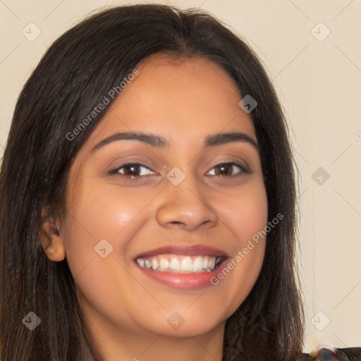 Joyful latino young-adult female with long  brown hair and brown eyes