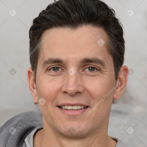 Joyful white adult male with short  brown hair and brown eyes