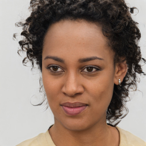 Joyful black young-adult female with medium  brown hair and brown eyes
