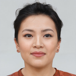 Joyful asian young-adult female with short  brown hair and brown eyes