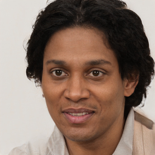 Joyful black adult female with short  brown hair and brown eyes