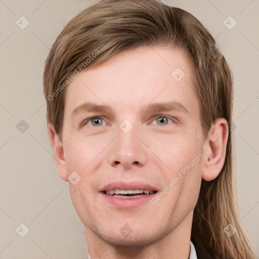 Joyful white young-adult male with short  brown hair and blue eyes