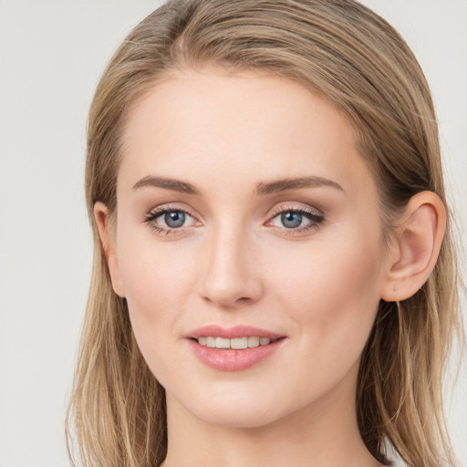 Joyful white young-adult female with long  brown hair and grey eyes