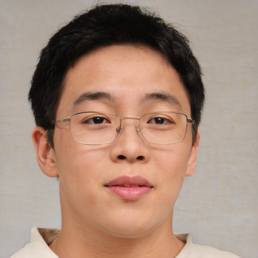 Joyful asian adult male with short  brown hair and brown eyes