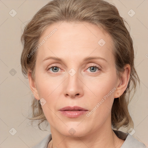 Joyful white adult female with medium  brown hair and blue eyes