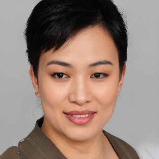 Joyful asian young-adult female with short  black hair and brown eyes